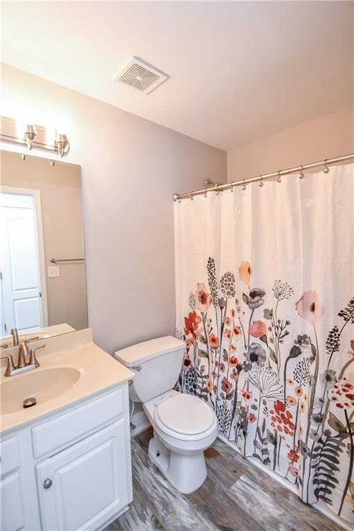 75 Ashebrooke Way Jefferson, GA 30549 - Photo 69 of 84 a bathroom with a toilet sink and mirror