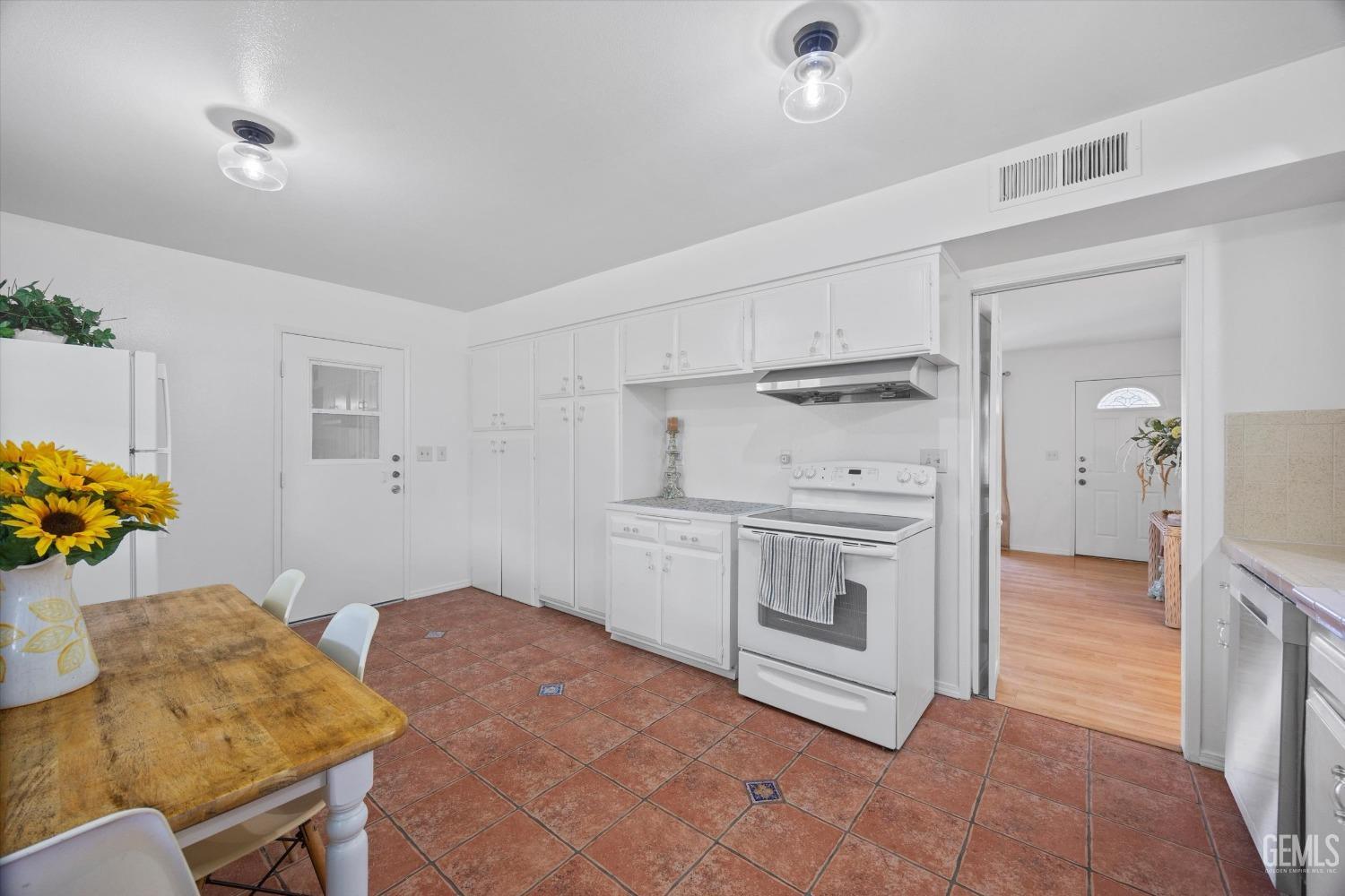 Undisclosed Address Bakersfield, CA 93309 - Photo 14 of 47 a kitchen with sink cabinets and stove