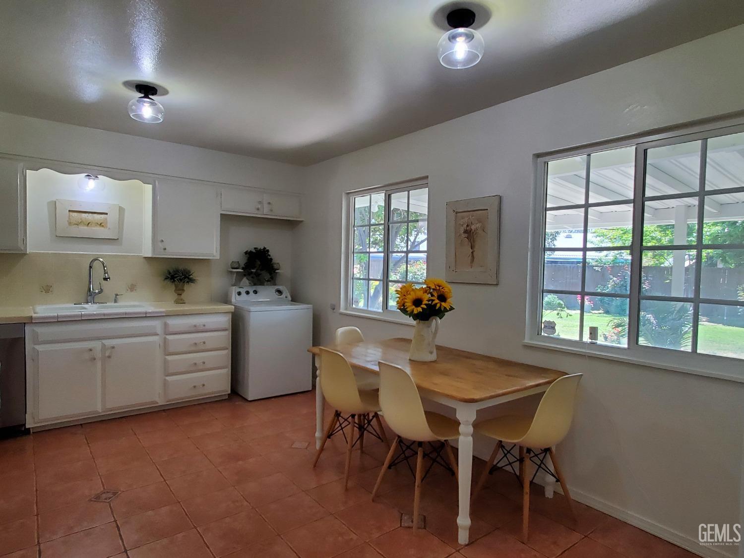 Undisclosed Address Bakersfield, CA 93309 - Photo 17 of 47 a kitchen with sink table and chairs