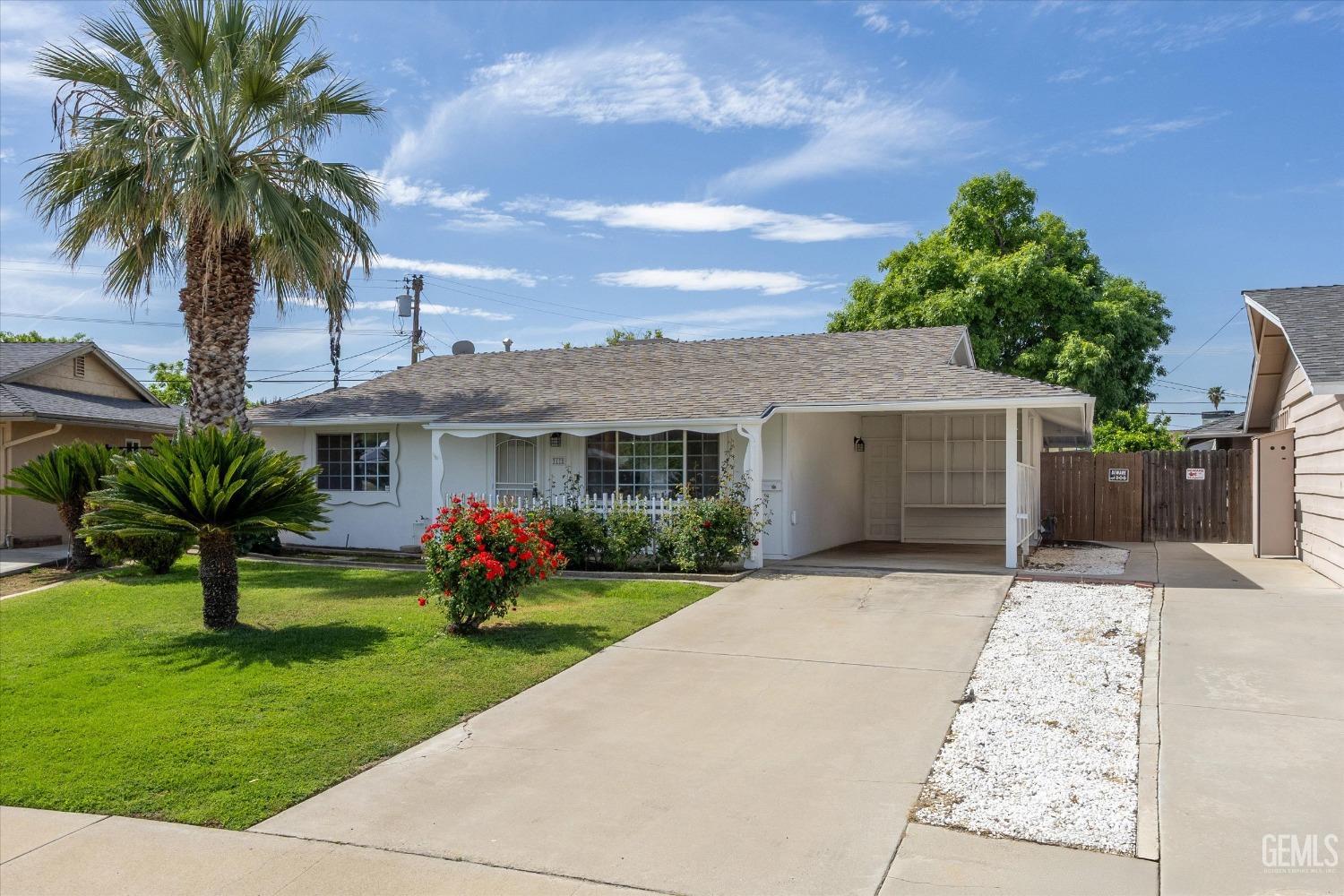 Undisclosed Address Bakersfield, CA 93309 - Photo 3 of 47 front view of house with a yard and potted plants