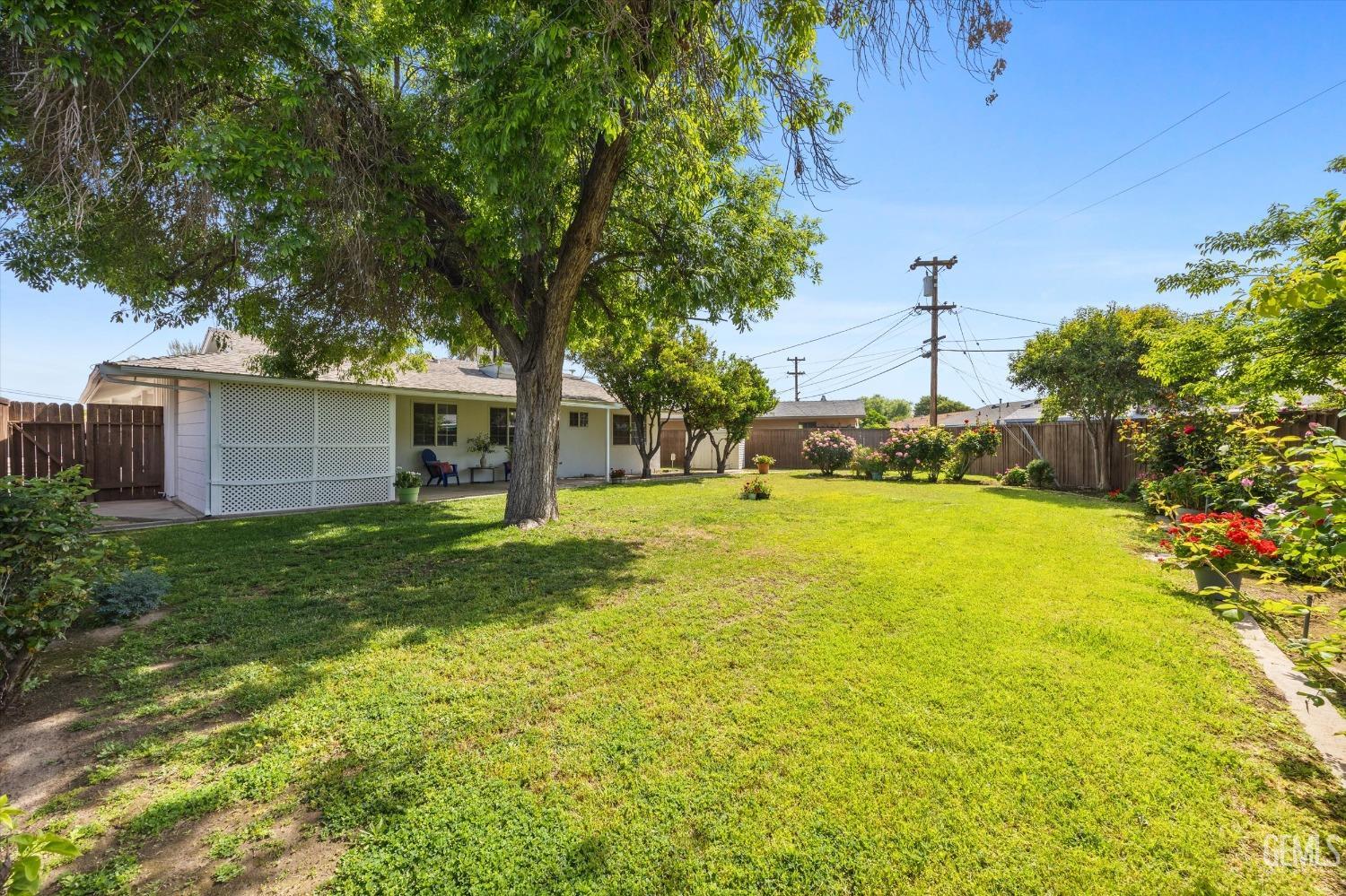 Undisclosed Address Bakersfield, CA 93309 - Photo 40 of 47 a view of a backyard with table and chairs and potted plants