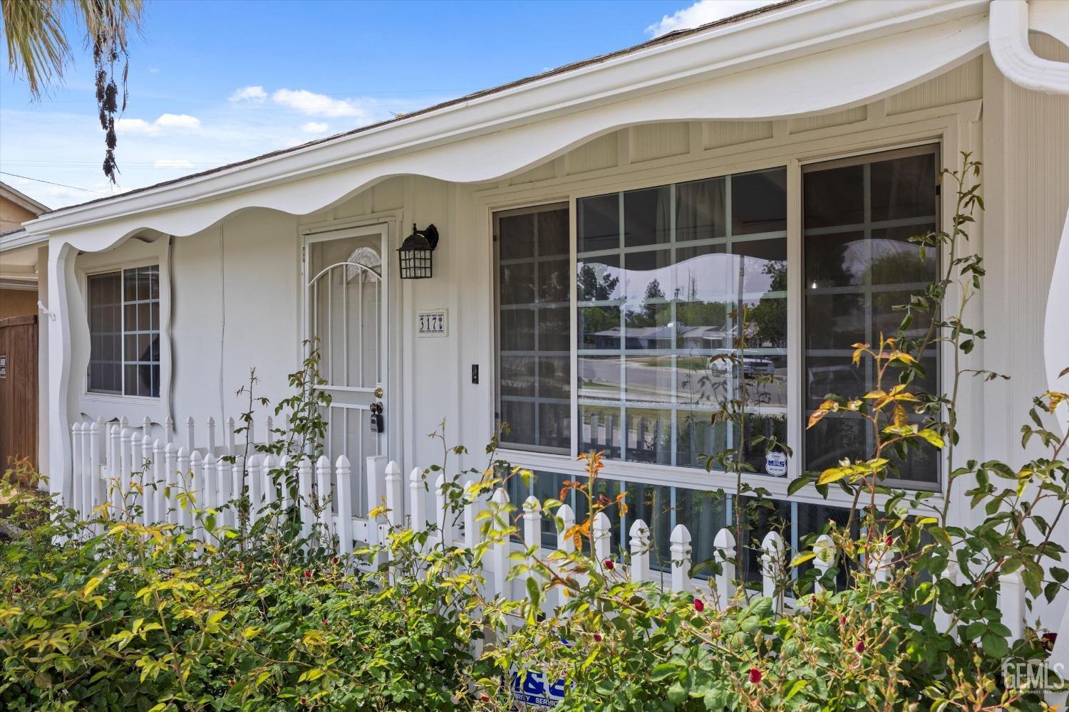 Undisclosed Address Bakersfield, CA 93309 - Photo 4 of 47 front view of a house with a flower plants