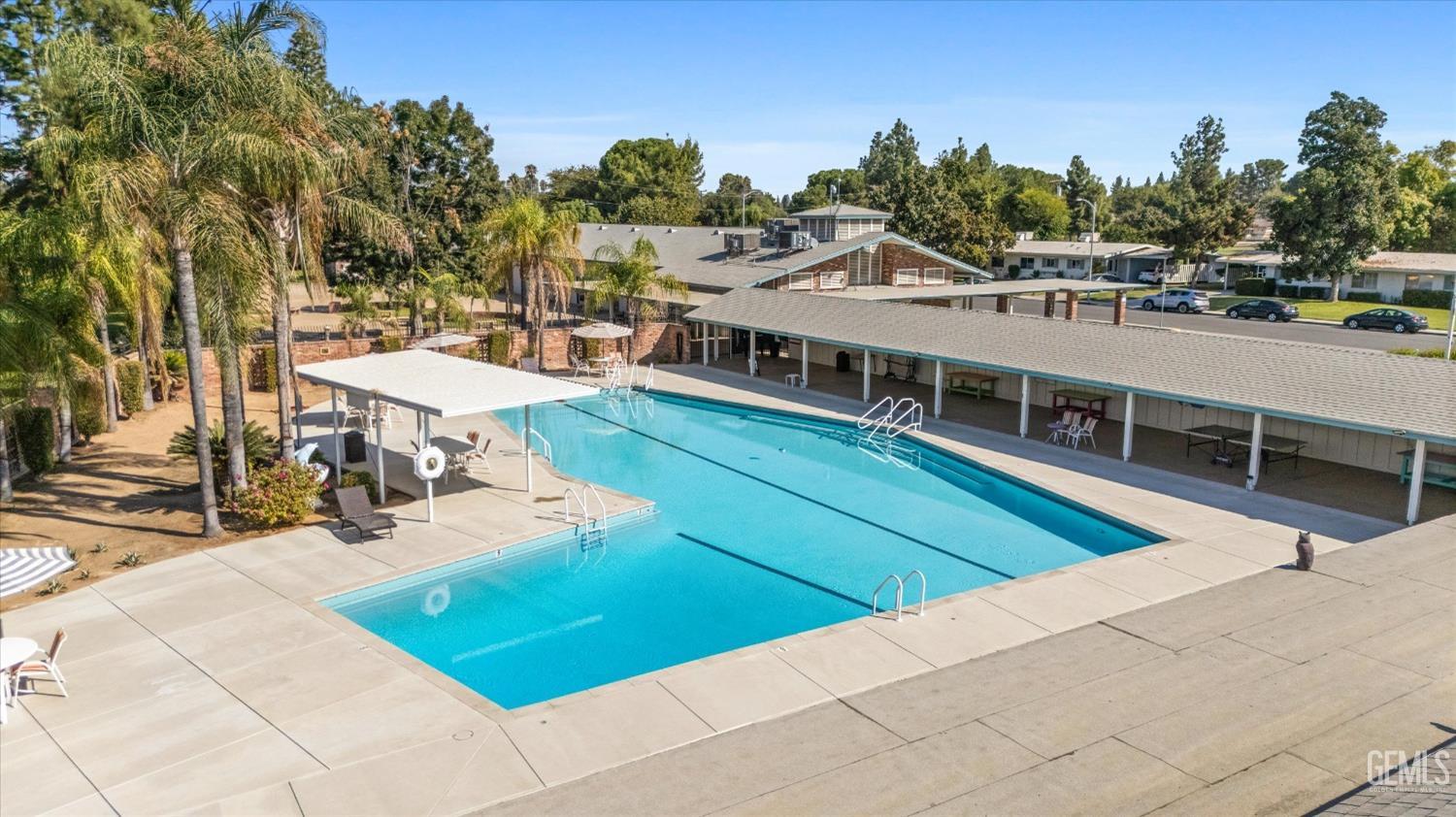 Undisclosed Address Bakersfield, CA 93309 - Photo 44 of 47 a view of a swimming pool with seating area and trees in the background