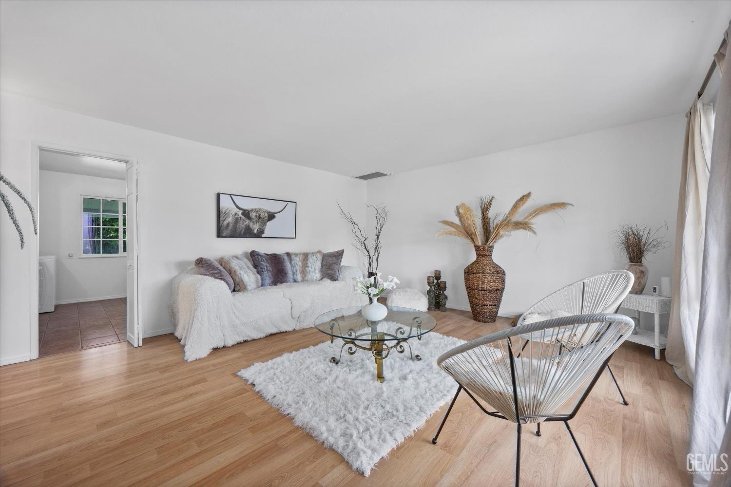 Undisclosed Address Bakersfield, CA 93309 - Photo 6 of 47 a living room with furniture and wooden floor