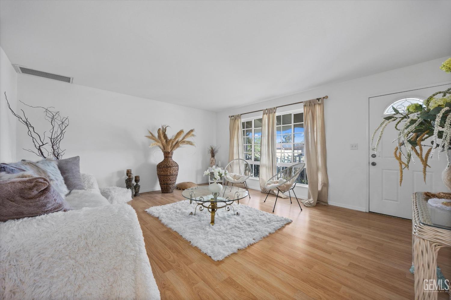 Undisclosed Address Bakersfield, CA 93309 - Photo 8 of 47 a living room with furniture large window and wooden floor