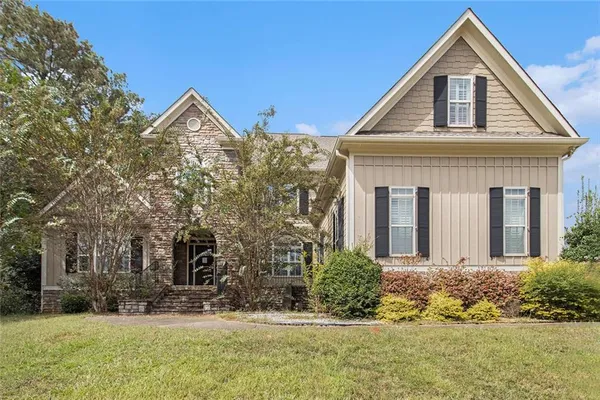 a front view of a house with a yard