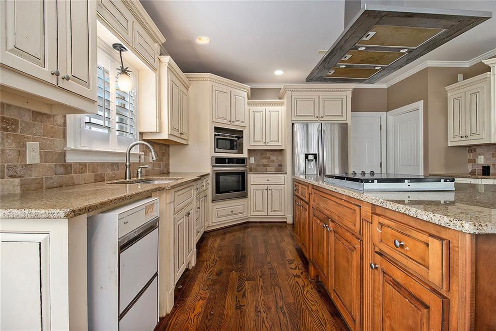 70 Alcovy Reserve Way Covington, GA 30014 - Photo 12 of 30 a large kitchen with stainless steel appliances granite countertop a lot of counter space and wooden floors