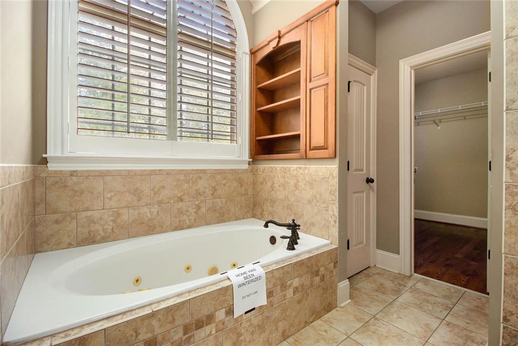 70 Alcovy Reserve Way Covington, GA 30014 - Photo 19 of 30 a bathroom with a bathtub and a shower