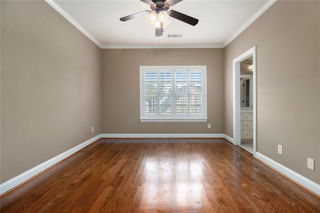 70 Alcovy Reserve Way Covington, GA 30014 - Photo 22 of 30 a view of an empty room with wooden floor and a window