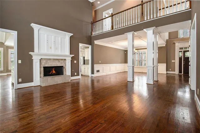 a view of an entryway with wooden floor and a fireplace