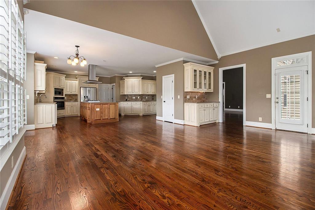 70 Alcovy Reserve Way Covington, GA 30014 - Photo 8 of 30 a living room with stainless steel appliances kitchen island hard wood floors and fireplace