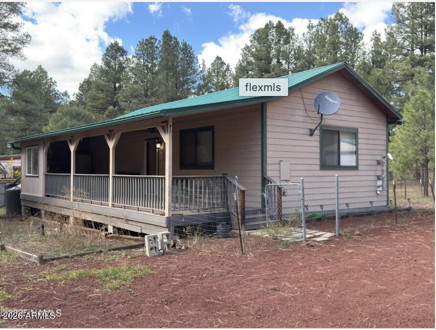 7261 East Long Bow Drive Williams, AZ 86046 - Photo 1 of 26 a front view of a house with a yard