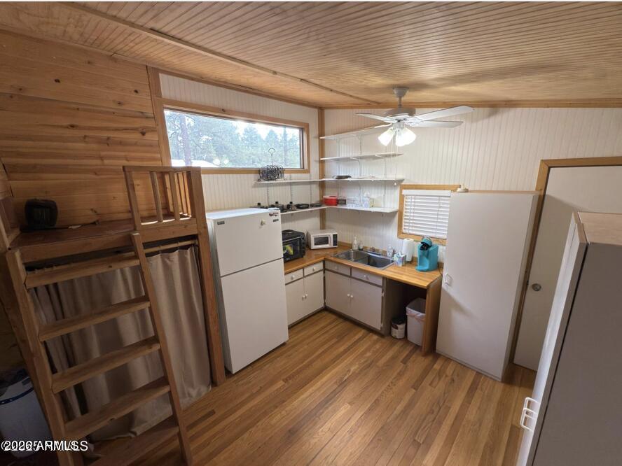 7261 East Long Bow Drive Williams, AZ 86046 - Photo 15 of 26 a kitchen with a refrigerator wooden floor and window