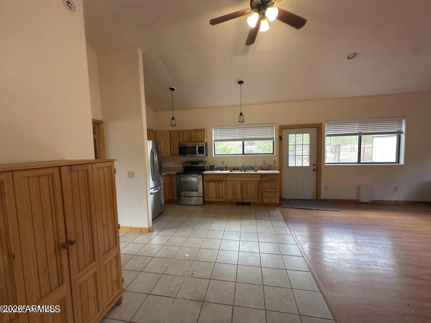 7261 East Long Bow Drive Williams, AZ 86046 - Photo 9 of 26 a view of a kitchen with a sink dishwasher and a refrigerator