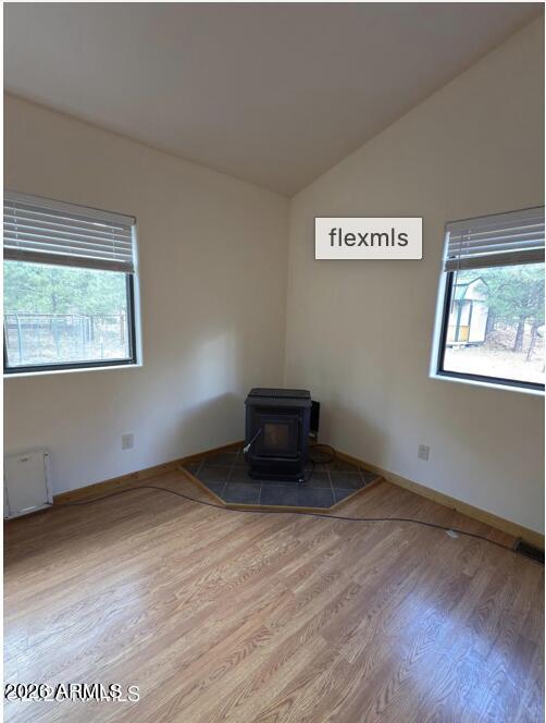 7261 East Long Bow Drive Williams, AZ 86046 - Photo 10 of 26 a view of an empty room with wooden floor and a window