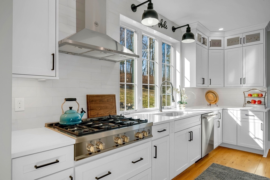 62 Seven Sister Road Haverhill, MA 01830 - Photo 11 of 42 a kitchen with stainless steel appliances granite countertop a stove and a sink