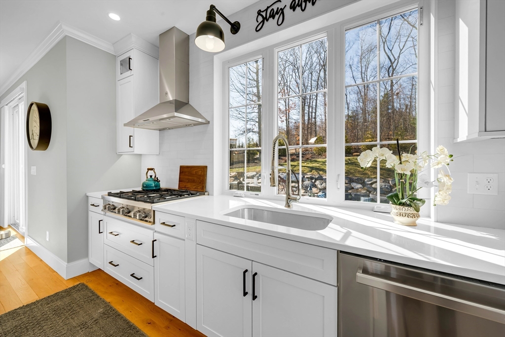 62 Seven Sister Road Haverhill, MA 01830 - Photo 12 of 42 a kitchen with stainless steel appliances granite countertop a sink a stove and a large window