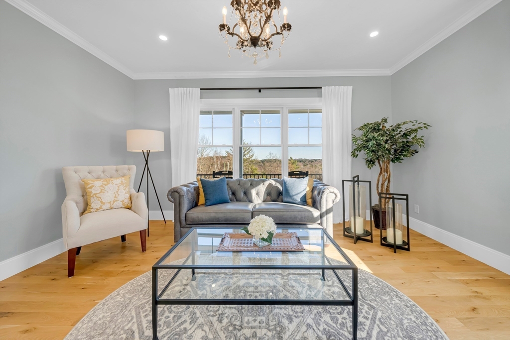 62 Seven Sister Road Haverhill, MA 01830 - Photo 18 of 42 a living room with furniture a chandelier and a rug