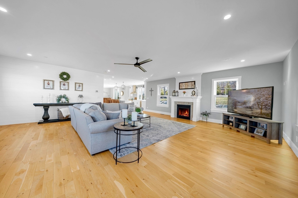 62 Seven Sister Road Haverhill, MA 01830 - Photo 22 of 42 a living room with furniture a fireplace and a flat screen tv