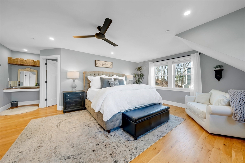 62 Seven Sister Road Haverhill, MA 01830 - Photo 24 of 42 a spacious bedroom with a bed a couch and a couch with wooden floor