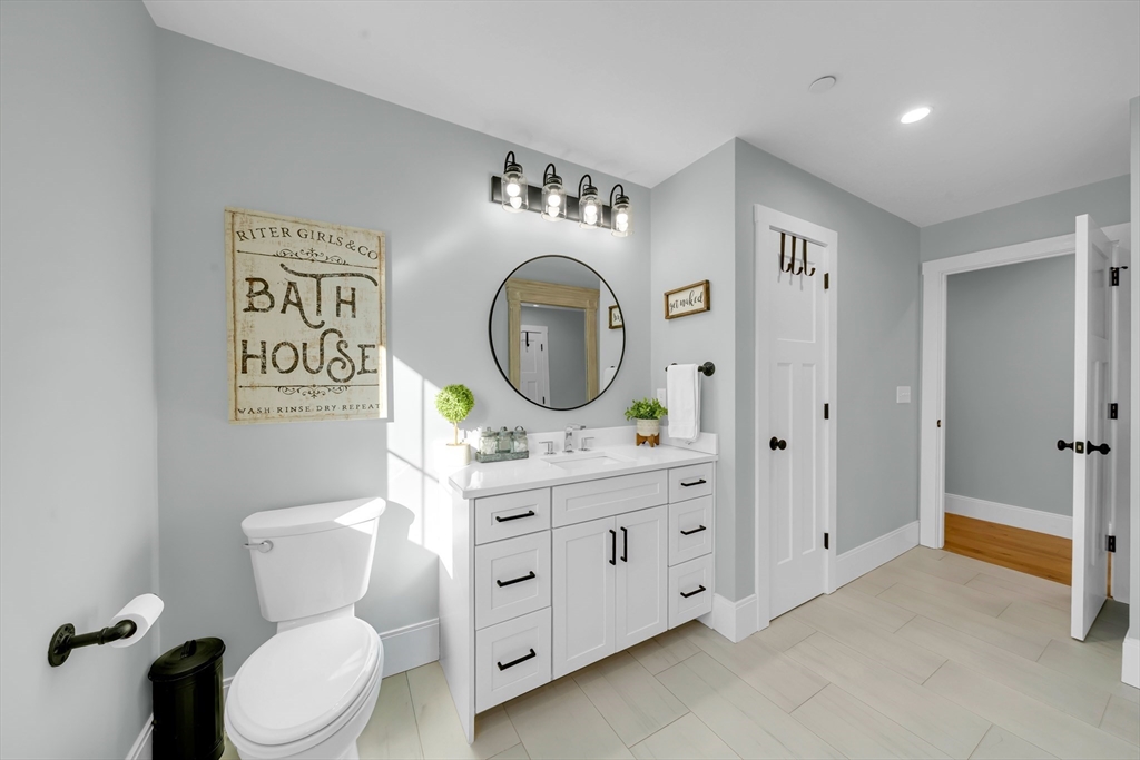 62 Seven Sister Road Haverhill, MA 01830 - Photo 33 of 42 a bathroom with a toilet a sink and a mirror