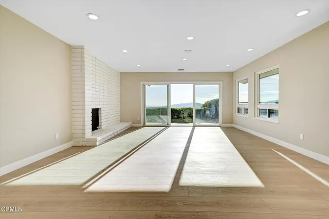 a room with a bed and a large window