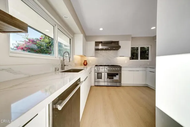 a stove top oven sitting inside of a kitchen