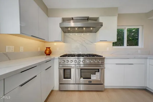 a kitchen with a sink stove and refrigerator