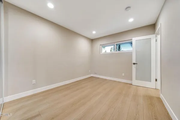 an empty room with windows and closet
