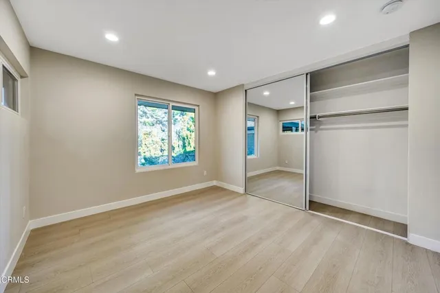 a view of hallway with wooden floor