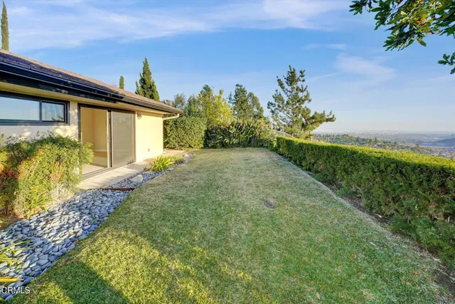 a view of a chairs and table in the backyard