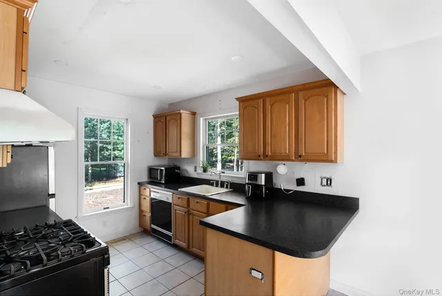 a kitchen with a sink stove top oven and cabinets