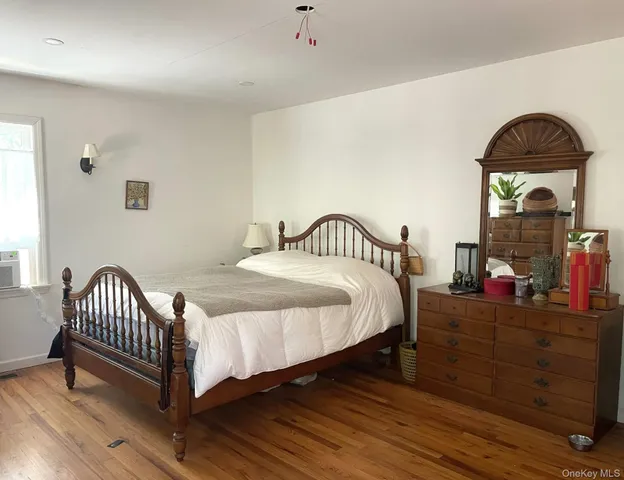 a bedroom with a bed and a dresser