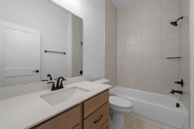 an empty room with a window and a ceiling fan