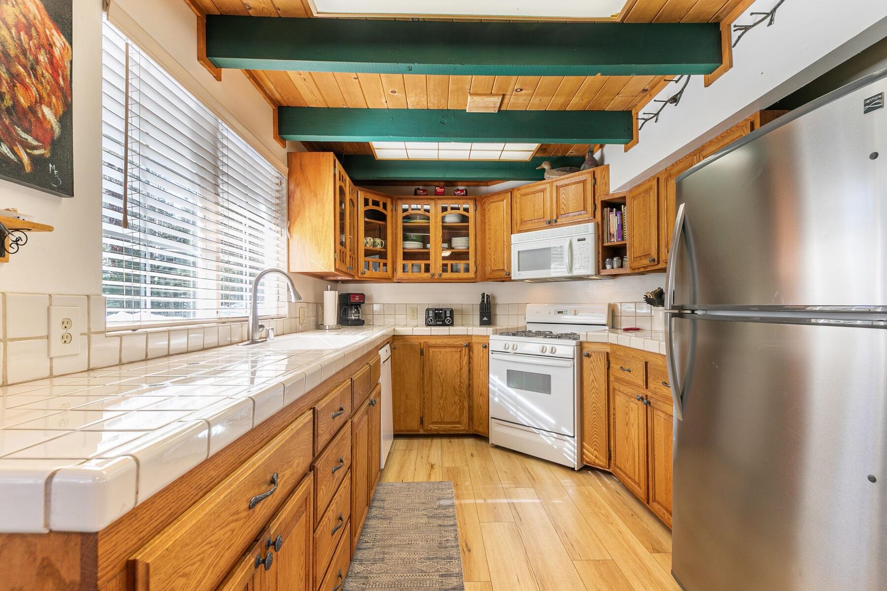 5749 Dodowah Road Carnelian Bay, CA 96140 - Photo 11 of 28 a kitchen with stainless steel appliances granite countertop a sink and a refrigerator