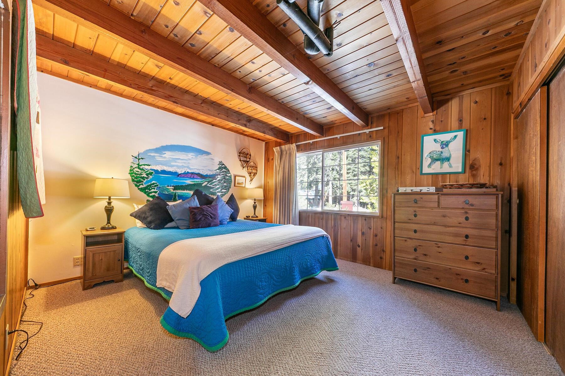 5749 Dodowah Road Carnelian Bay, CA 96140 - Photo 14 of 28 a bedroom with a bed and a dresser next to a window