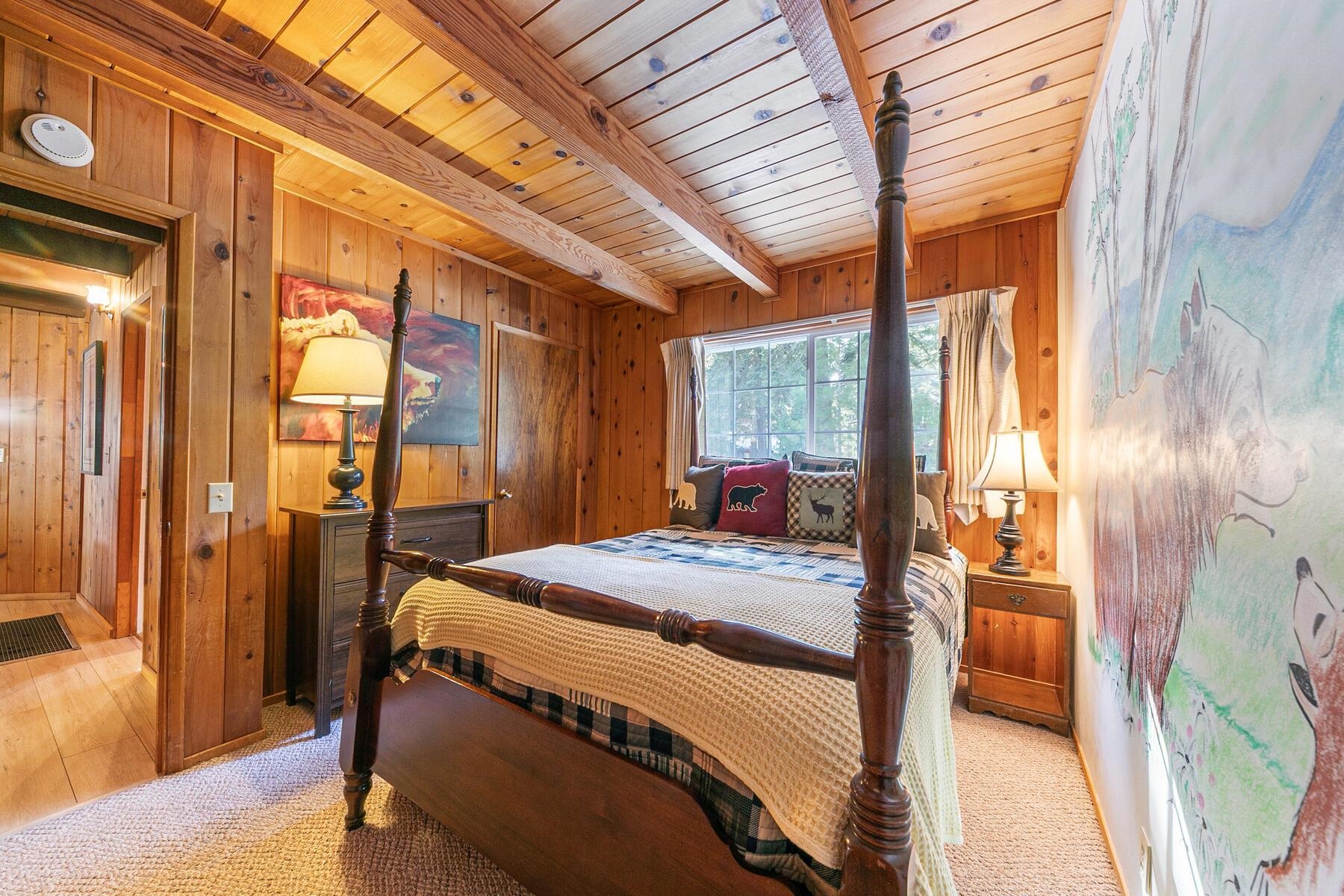 5749 Dodowah Road Carnelian Bay, CA 96140 - Photo 15 of 28 a bedroom with a bed and a dresser next to a window
