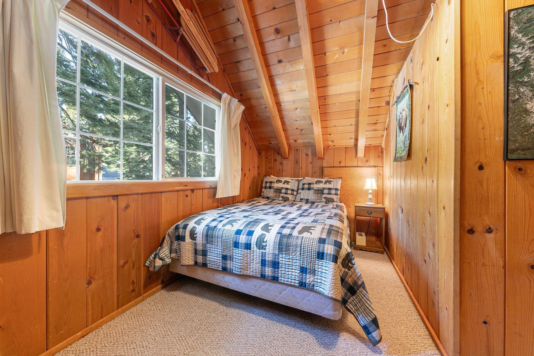 5749 Dodowah Road Carnelian Bay, CA 96140 - Photo 20 of 28 a bedroom with a bed and a window