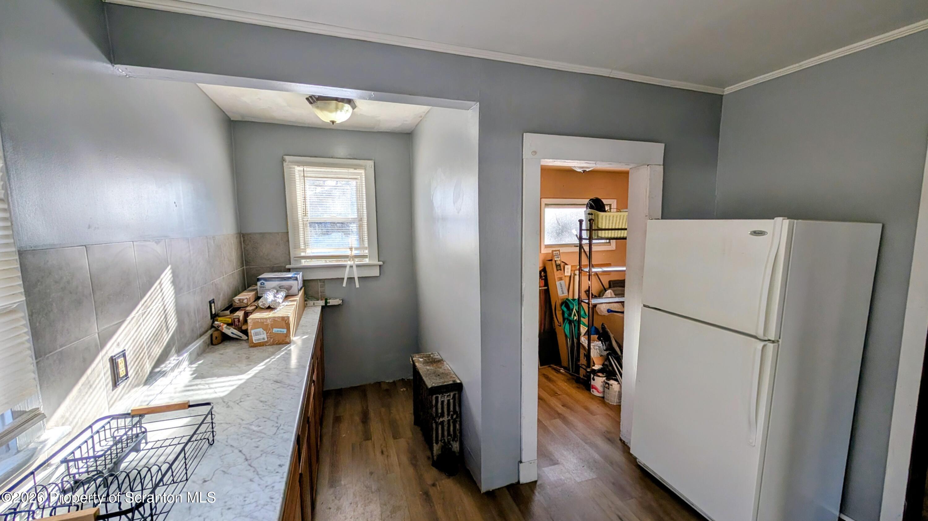 509 Main Street Duryea, PA 18642 - Photo 11 of 30 a kitchen with a refrigerator a stove top oven a sink and wooden floor