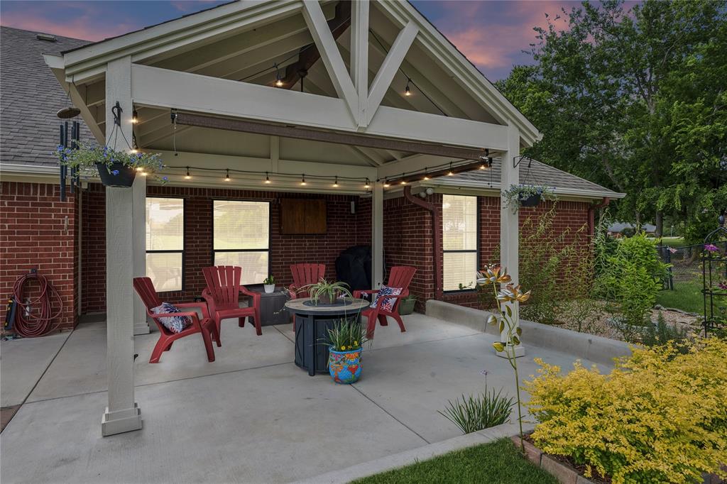 11211 Emerald Ranch Lane Forney, TX 75126 - Photo 2 of 35 Covered patio featuring a gabled roofline and string lighting