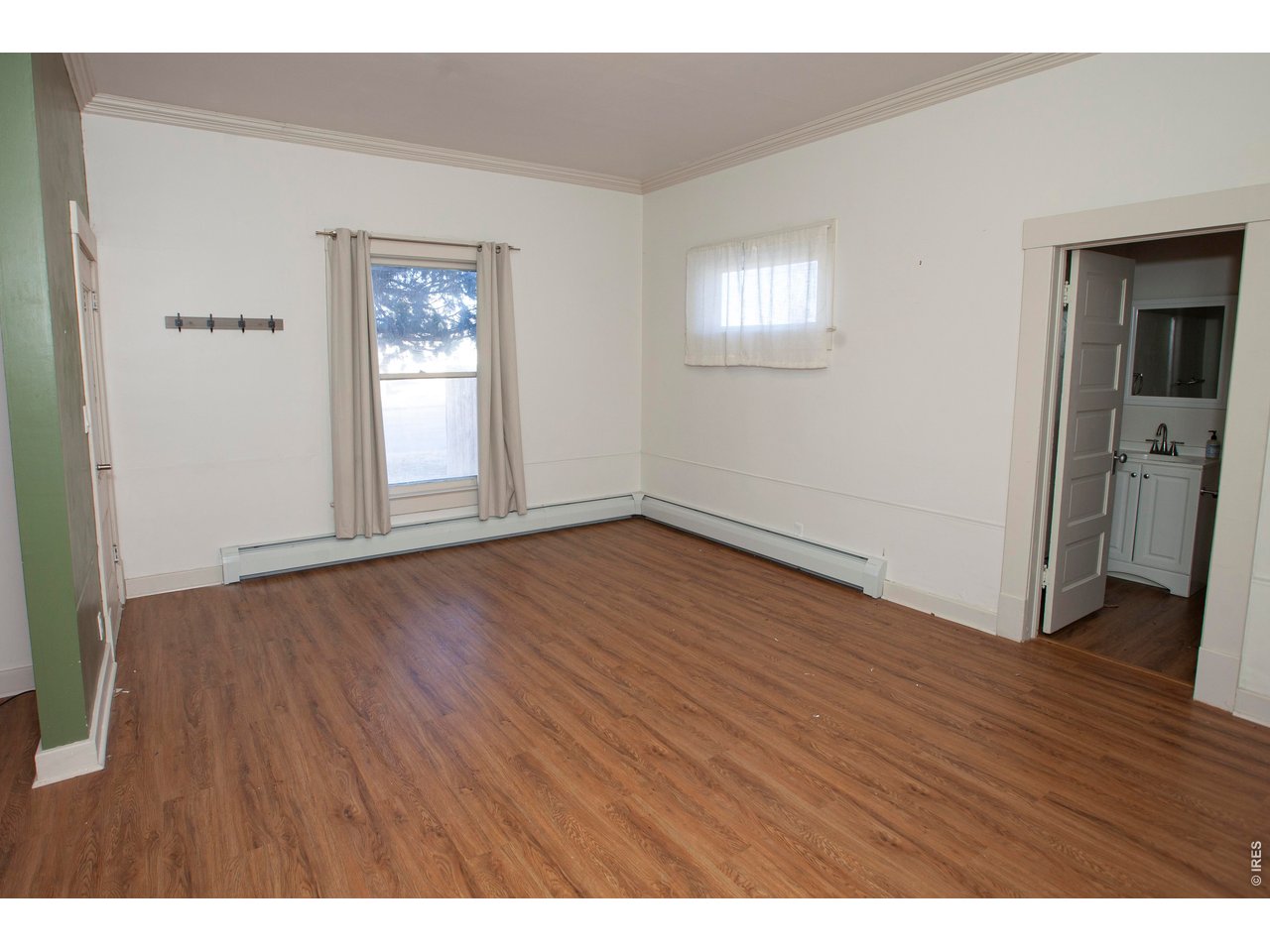 301 South 2nd Street Sterling, CO 80751 - Photo 14 of 49 a view of an empty room with wooden floor and a window