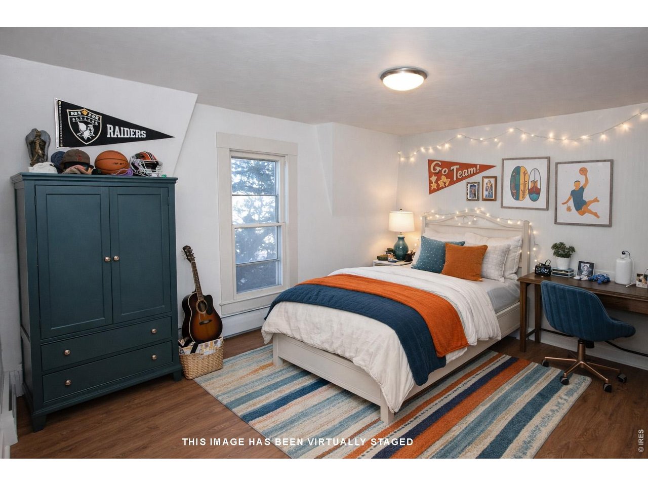 301 South 2nd Street Sterling, CO 80751 - Photo 21 of 49 a bedroom with a bed and wooden floor