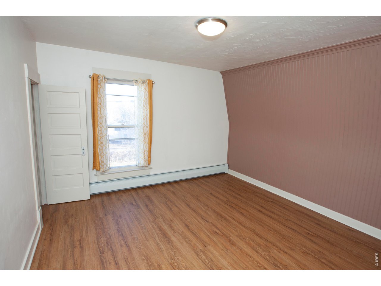 301 South 2nd Street Sterling, CO 80751 - Photo 26 of 49 a view of an empty room with wooden floor and a window
