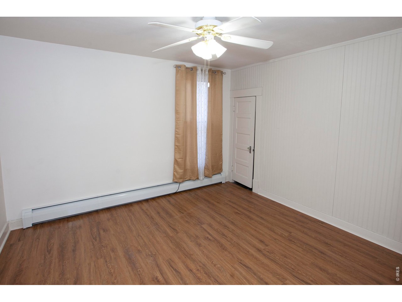 301 South 2nd Street Sterling, CO 80751 - Photo 37 of 49 a view of an empty room with chandelier fan and wooden floor