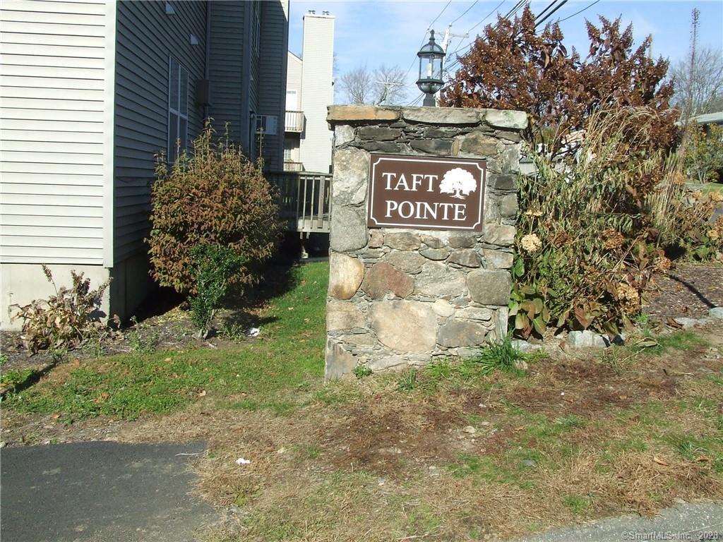 7 Taft Pointe, Unit 59 Waterbury, CT 06708 - Photo 1 of 1 a sign that is sitting in the middle of a yard