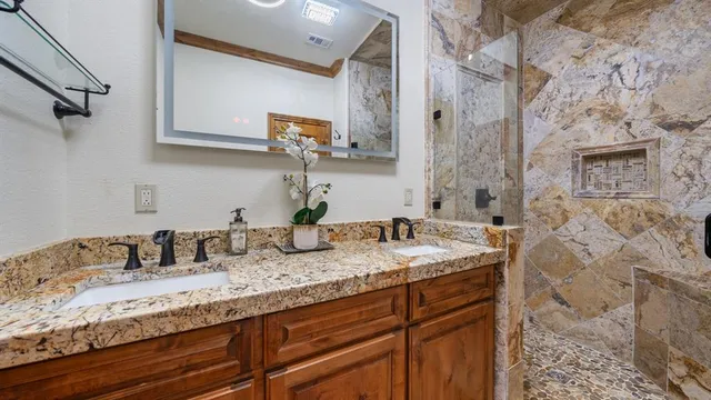 a bedroom with a bed and large windows