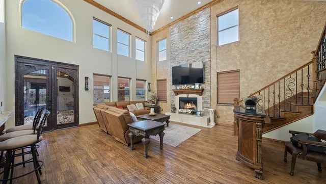 a living room with furniture stairs and a ceiling fan