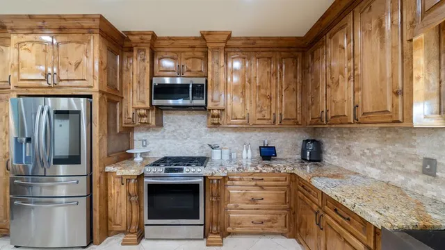 a kitchen with stainless steel appliances granite countertop a stove and a sink
