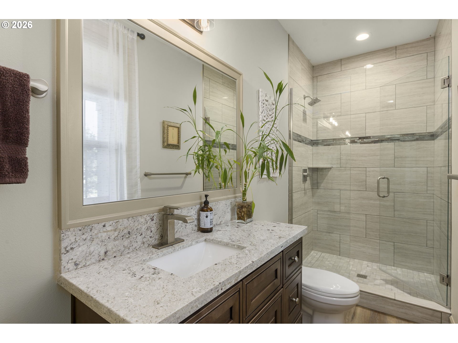 1668 Southeast 35th Terrace Gresham, OR 97080 - Photo 24 of 33 a bathroom with a granite countertop sink a mirror and shower