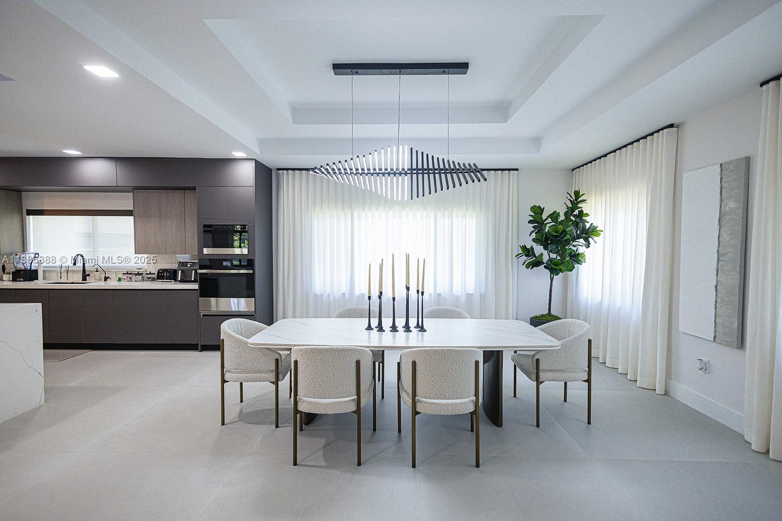 10506 Southwest 89th Place Miami, FL 33176 - Photo 14 of 51 a kitchen with a dining table chairs stainless steel appliances and cabinets